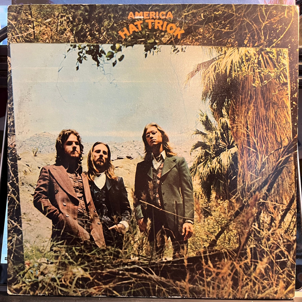 America (2) - Hat Trick (VINYL) | Near Mint (NM) Excellent (EX)