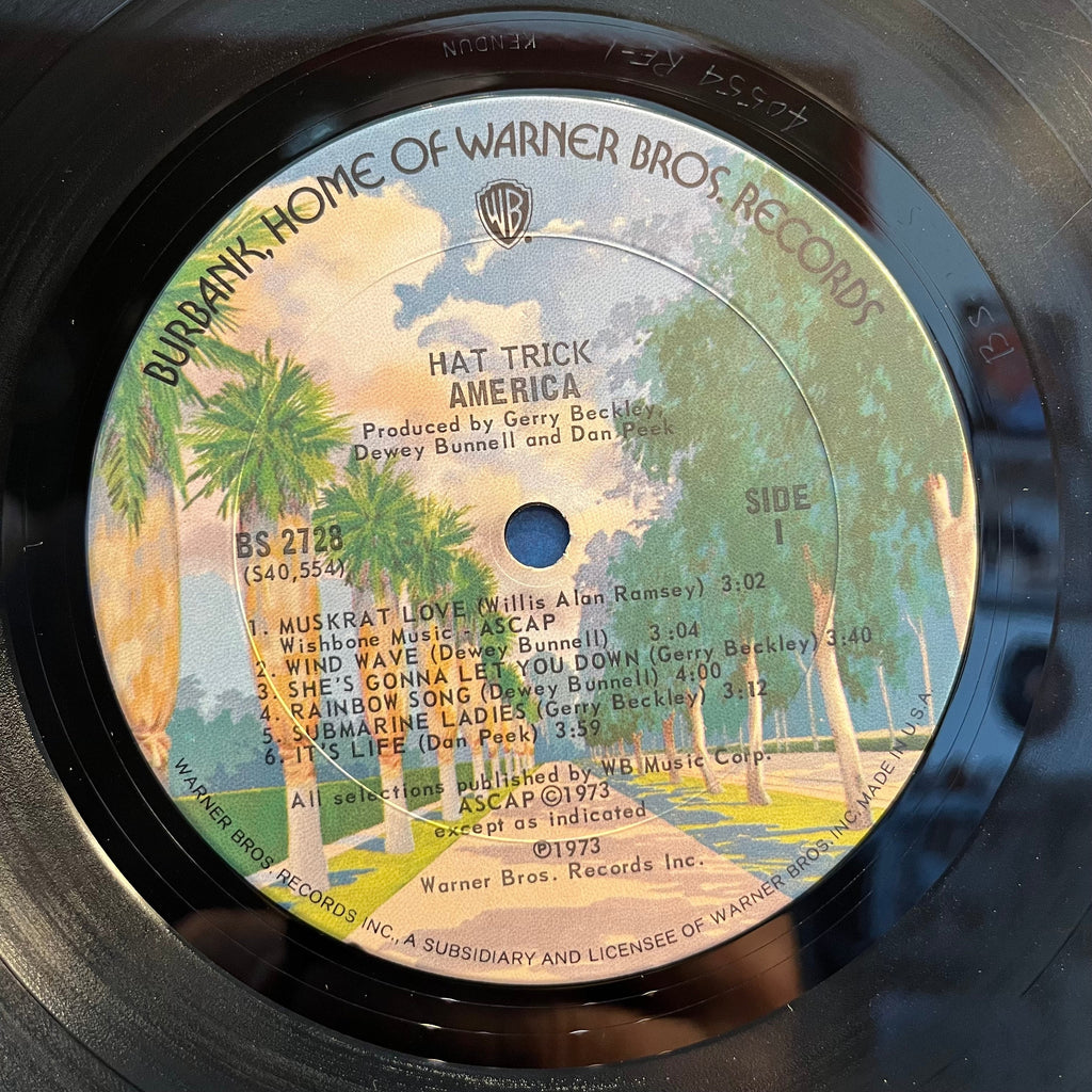 America (2) - Hat Trick (VINYL) | Near Mint (NM) Excellent (EX)